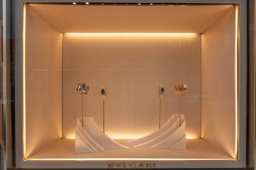 Luxury jewelry display in a well-lit boutique window.