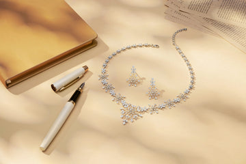 Diamond necklace and earrings with pen and pen