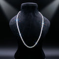 Pearl necklace on a black mannequin bust with dramatic lighting